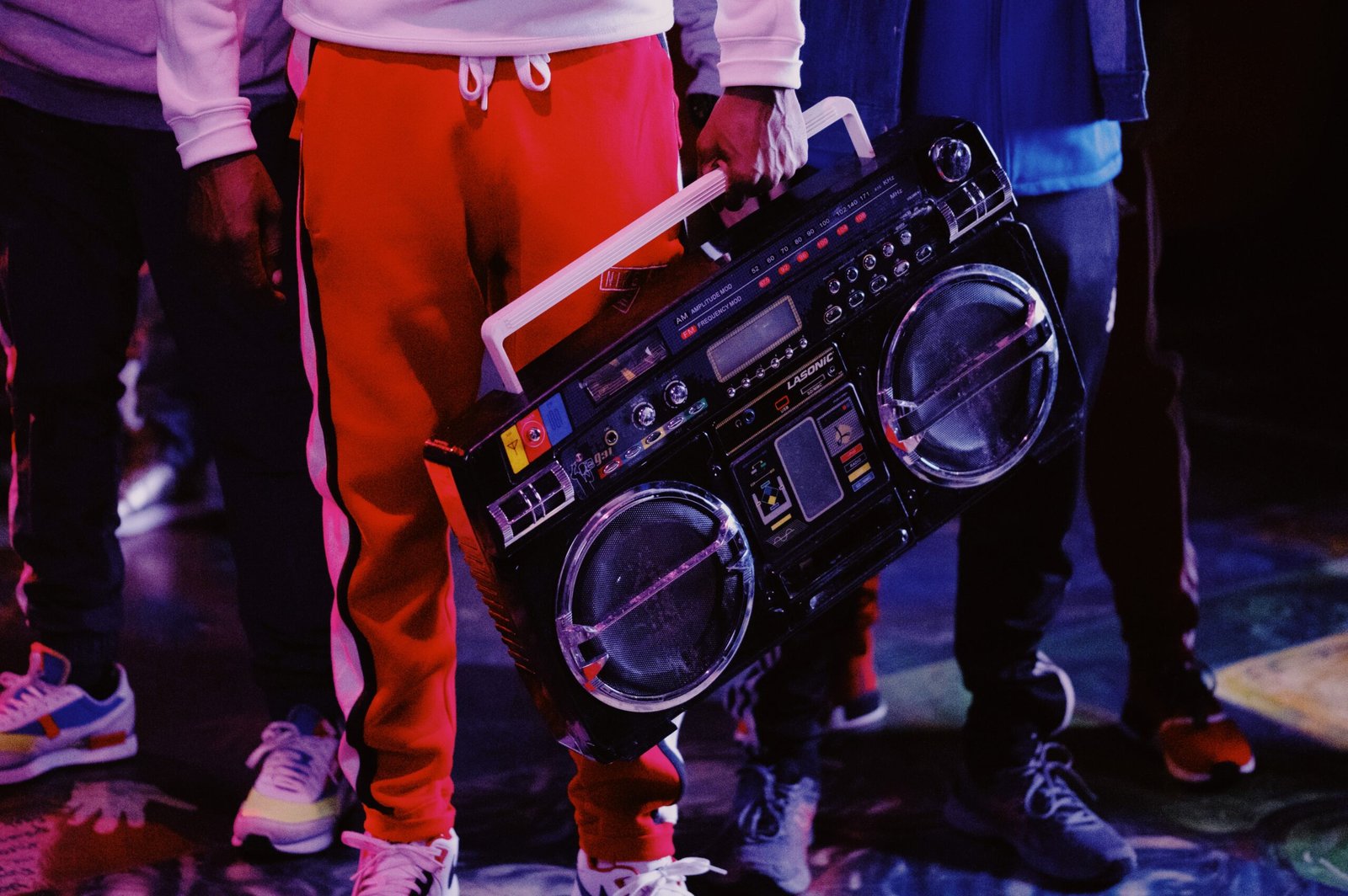 man in red jacket holding black dj controller